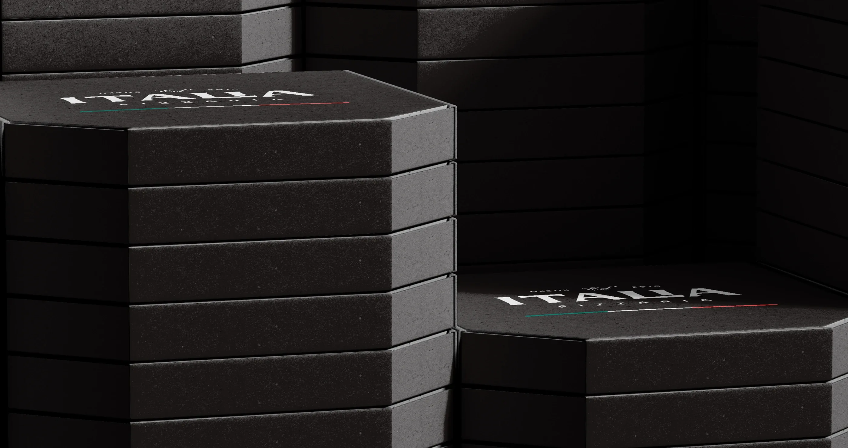 Stacks of black pizza boxes with the Ed' Italia Pizzeria logo