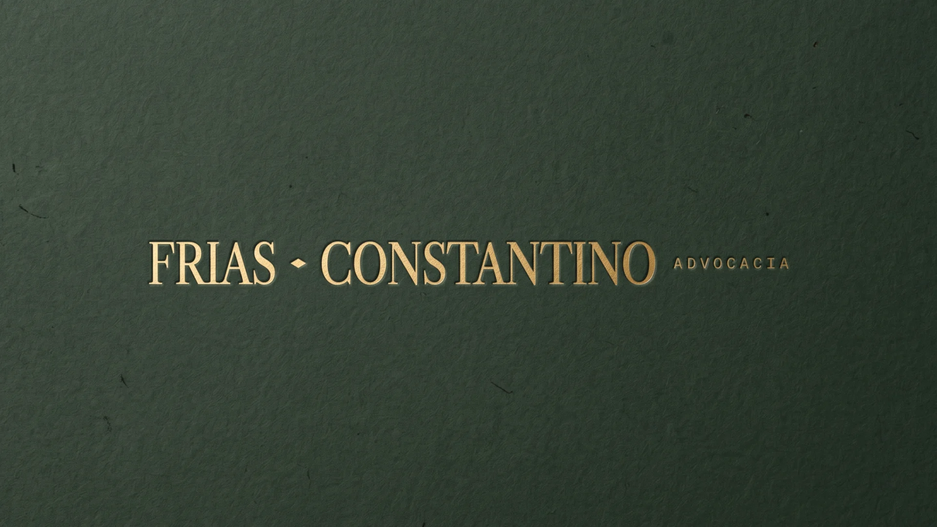 Frias Constantino Advocacia logo in embossed gold on textured dark-green paper