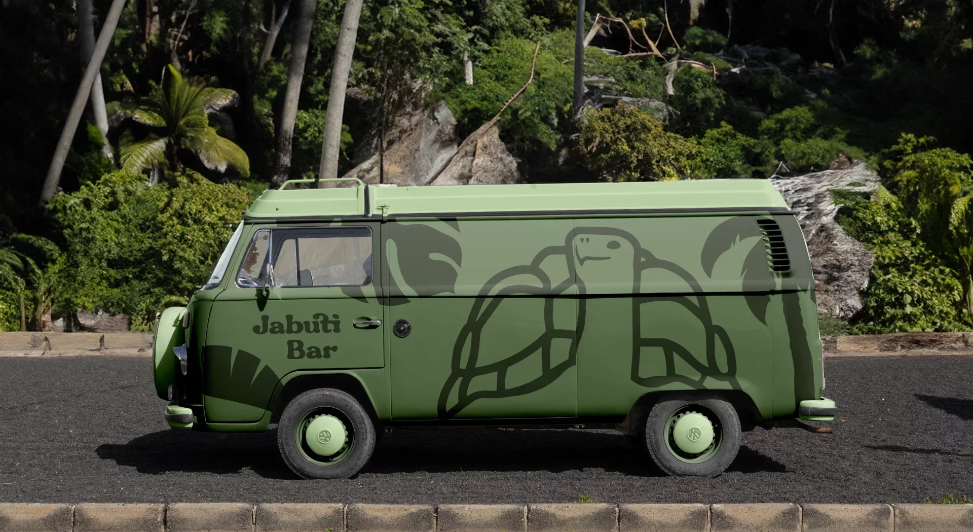 Green Kombi van with the JabutiBar tortoise parked among trees
