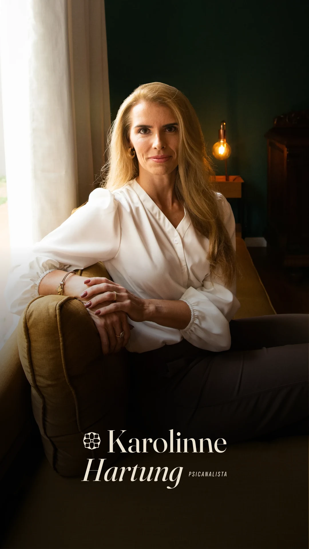 Karolinne Hartung seated by a window, with the logotype in the bottom corner