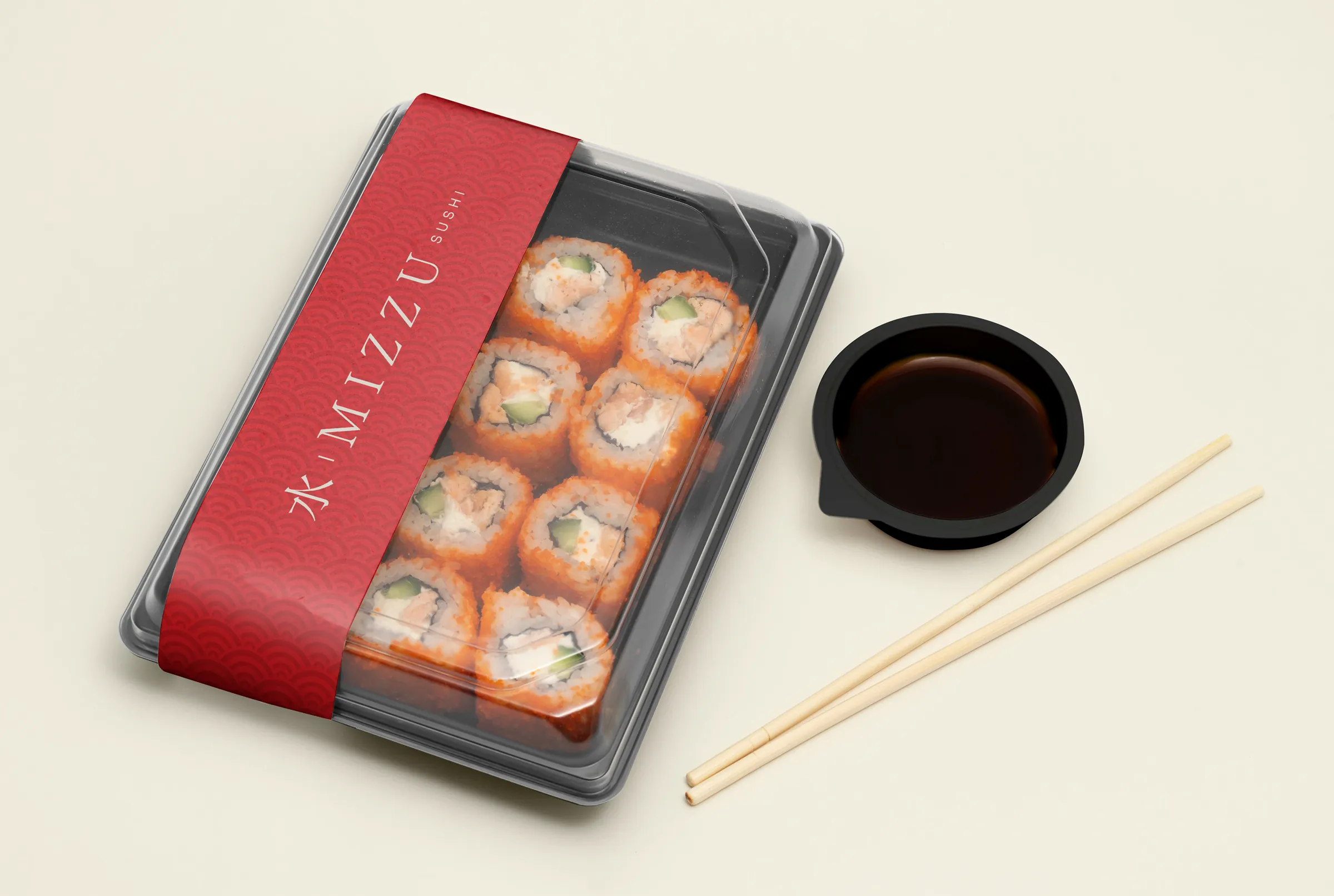 Sushi tray with a red Mizzu band, soy sauce and chopsticks