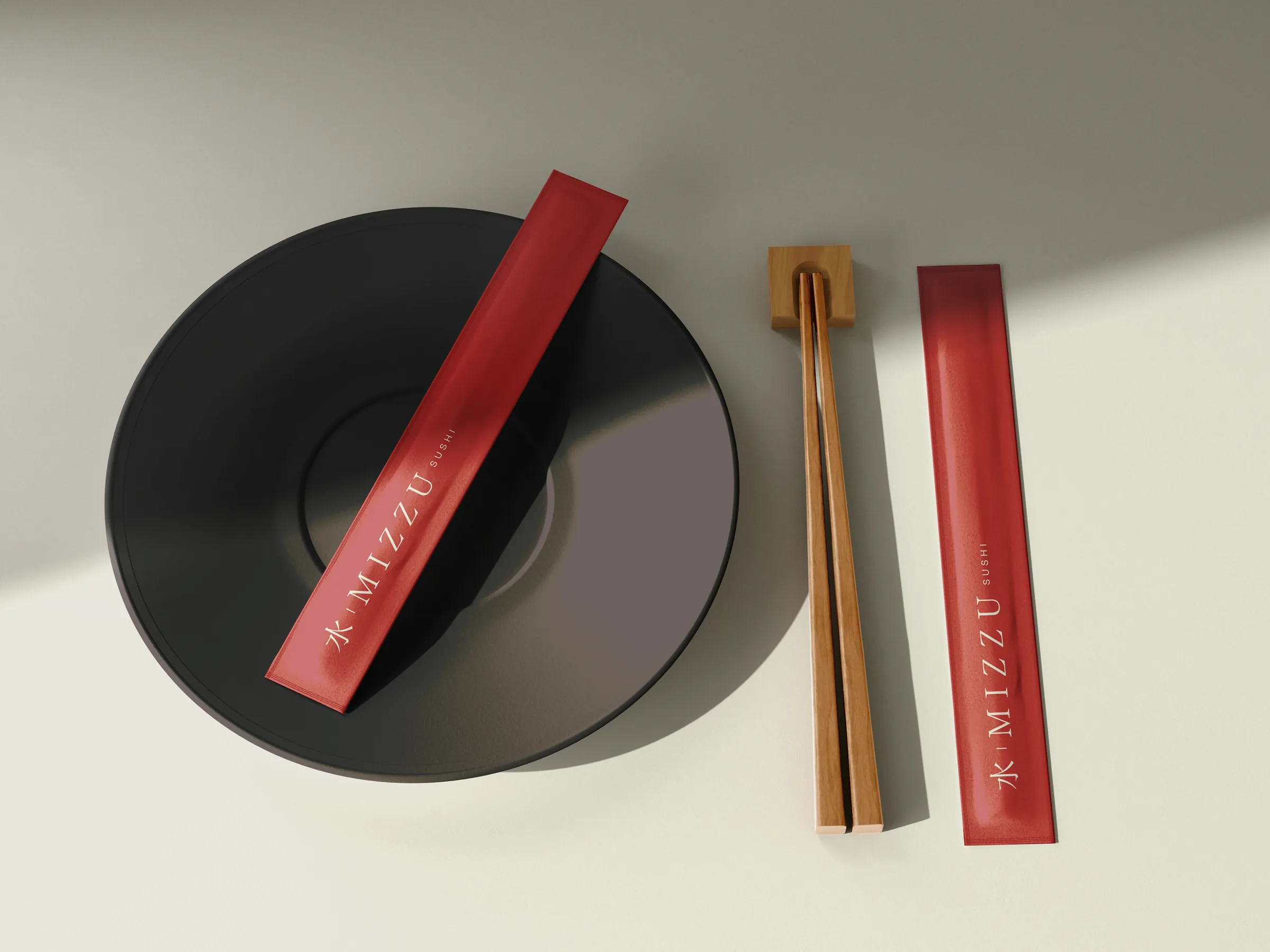 Chopsticks in a red Mizzu sleeve on a black plate